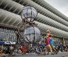 Performers doing acrobatics next to Timeless installation