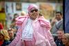 A lady in a pink outfit with sunglasses on during the Family Catwalk event at Encounter Festival 2024
