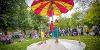Hikapee Circus Theatre performing with a large beach umbrella in Winckley Square