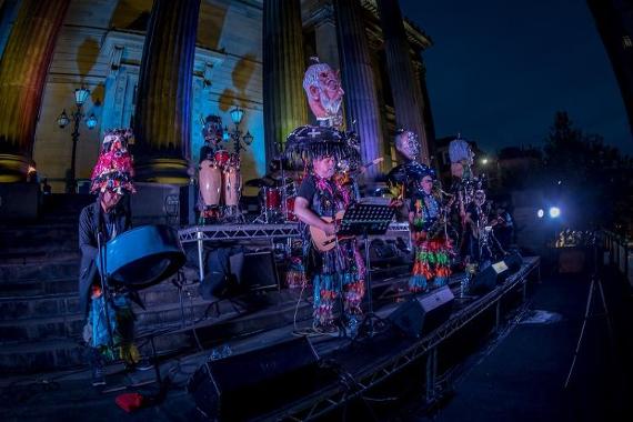 Musical performance taking place on the Harris balcony at night.