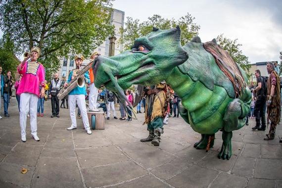 Men with trumpets and large dragon on Preston Flag Market.