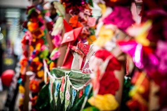 Display of colourful origami animals and decorations at a Lancashire Encounter workshop.