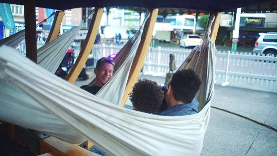People relaxing in hammocks installed at Preston Markets.