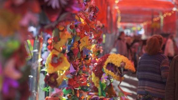View down long red Lancashire Encounter tent, with paper crafts on display.