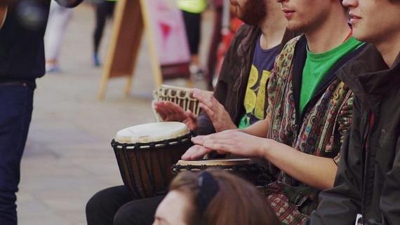 Group of men playing bongo drums.